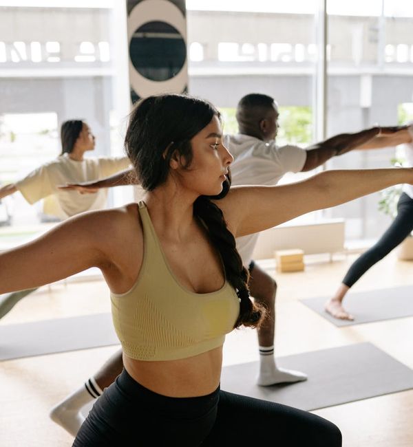 Person in a warrior yoga pose feeling strong and energetic.